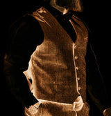 Person wearing a vintage-style vest and shirt with a blurred background